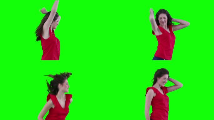 在绿色背景下积极跳舞的女人