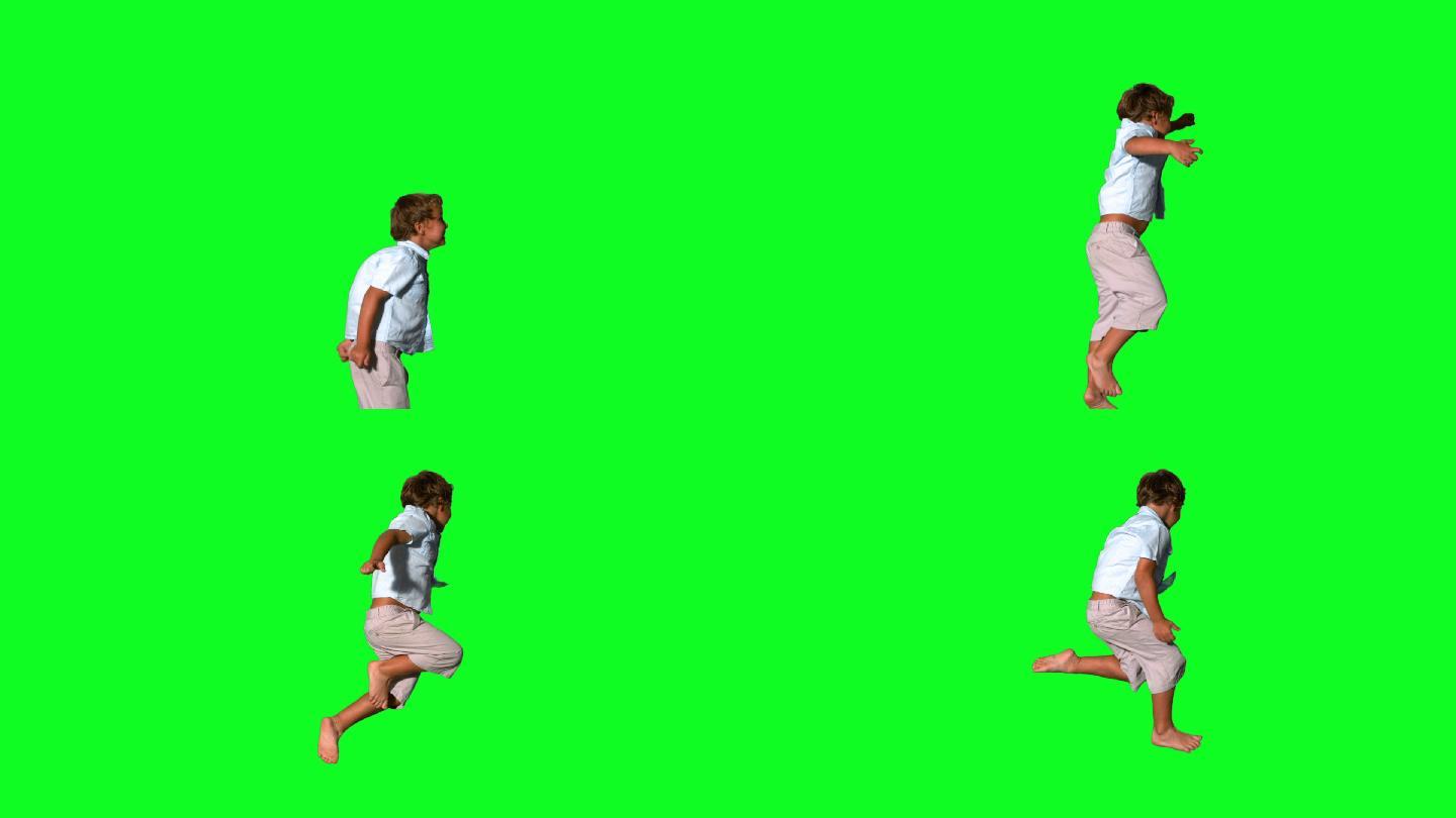 小男孩在绿色屏幕上跳跃的慢动作
