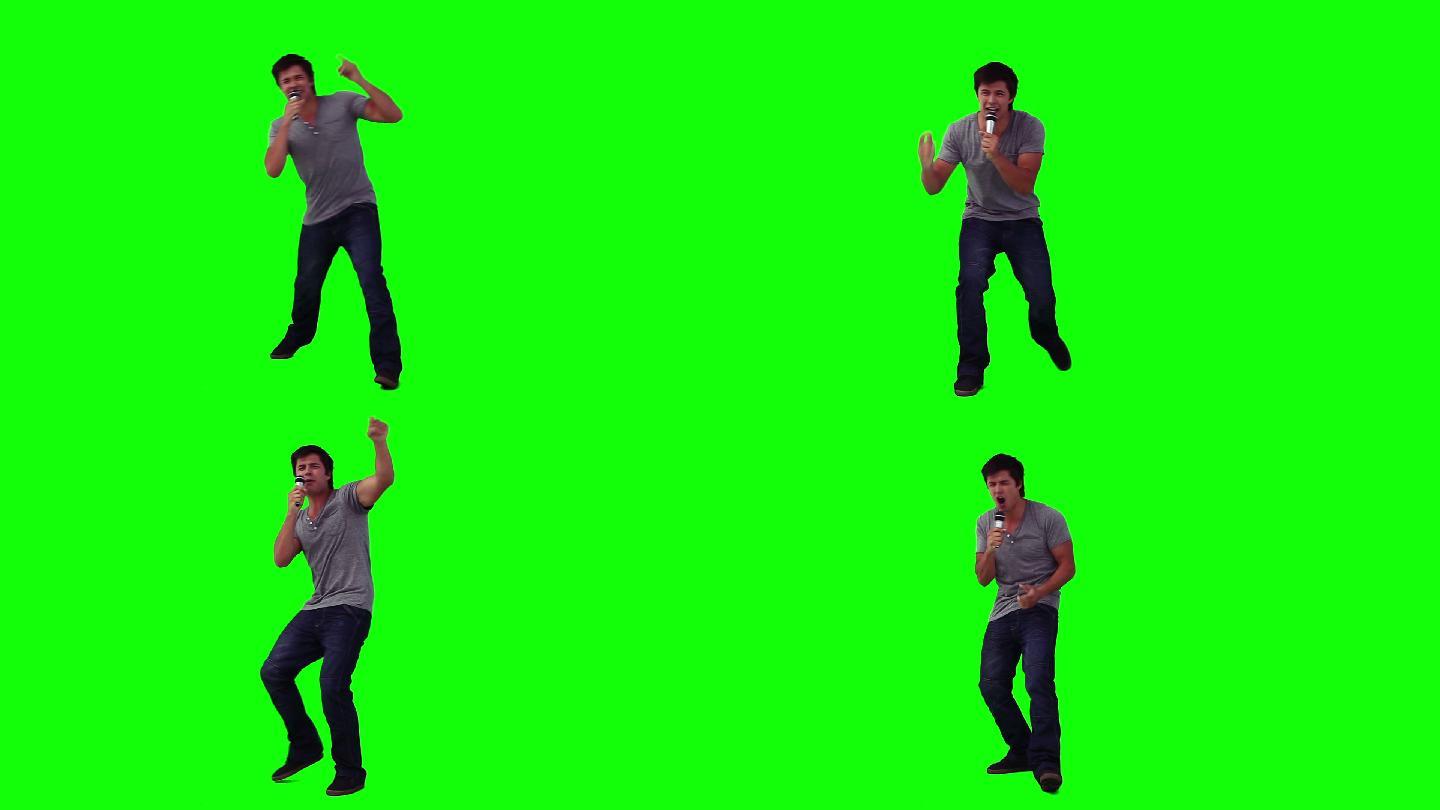 一个跳舞的男人在绿色背景下对着麦克风唱歌