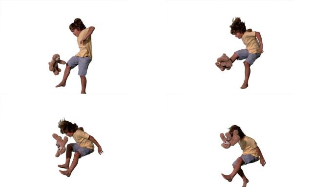 一个白人男孩跳跃踢毛绒玩具慢镜头，在白色背景下