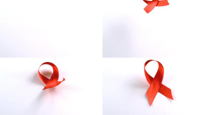 红色爱滋病意识丝带下降慢镜头，在白色背景下
