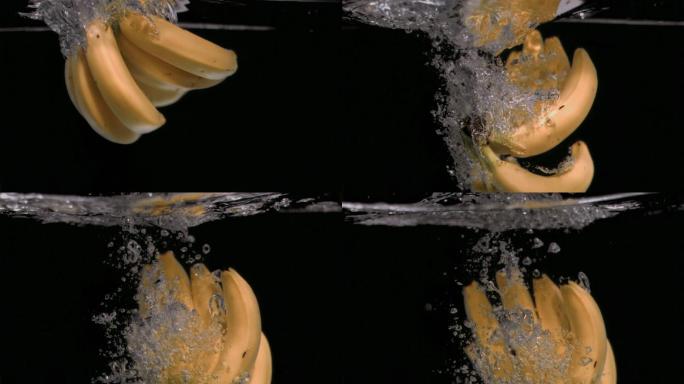 在黑色背景下，香蕉以超慢的动作落在水中