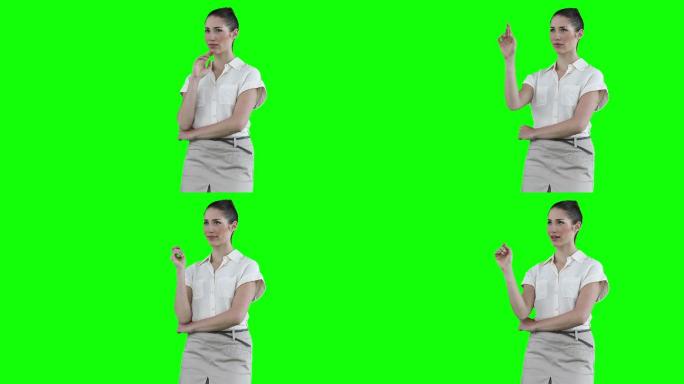 女商人在绿色背景下与虚拟触摸屏互动