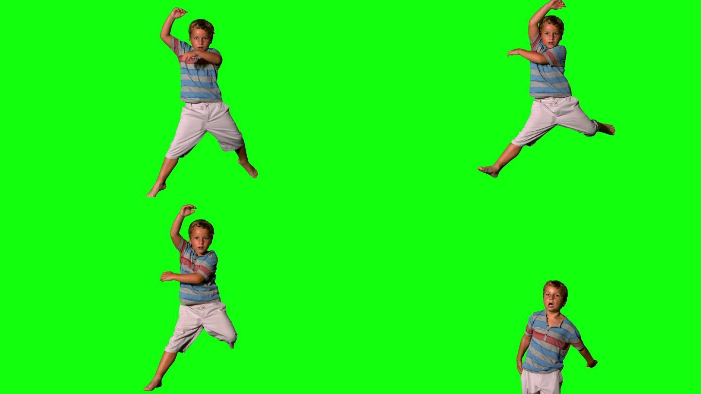 男孩跳在绿色屏幕上的慢动作