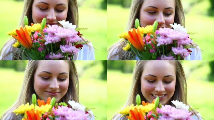 快乐的年轻女子捧着鲜花在农村