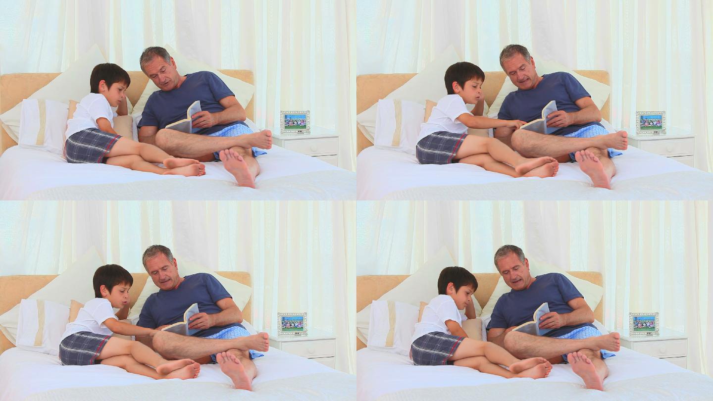 小男孩和他的爷爷在床上看书