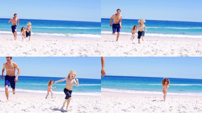 微笑的父亲和他的孩子们在海滩上跑步