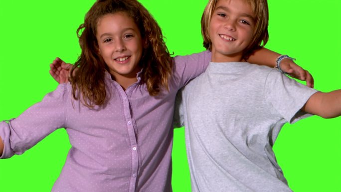 哥哥和妹妹在同一个镜头和拥抱在绿色屏幕的慢动作