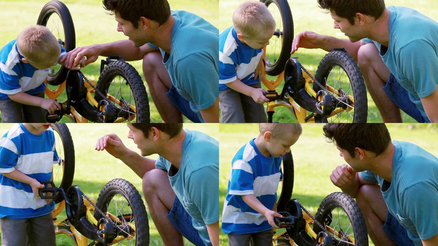 一个男孩和他的父亲在公园里转着一个轮子
