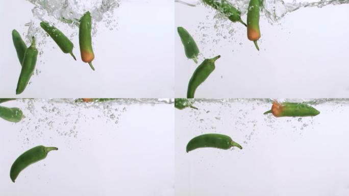 青椒在超级慢镜头下，在白色背景下是湿的