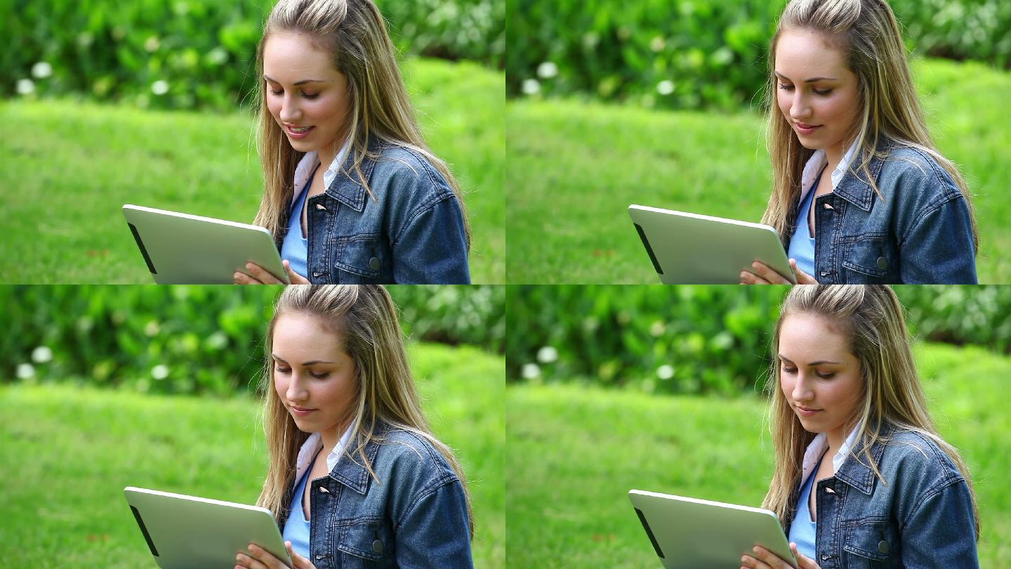 快乐的金发女人在乡下用平板电脑