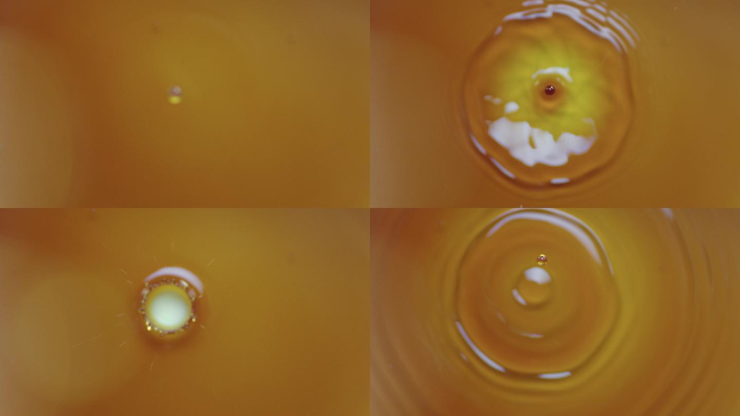 黄色液体滴落在水面荡起涟漪