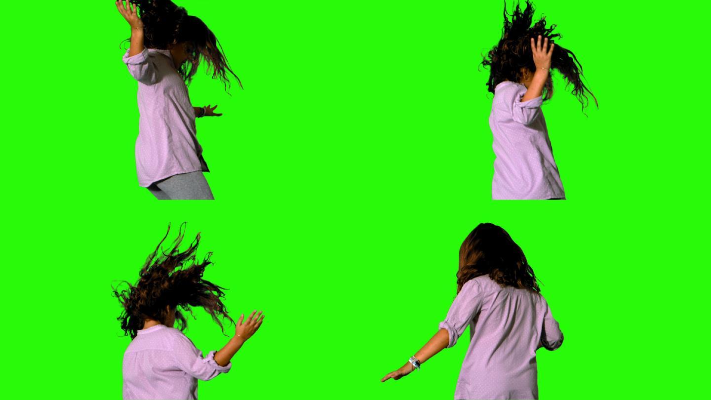小女孩在绿色屏幕上跳来跳去，慢动作