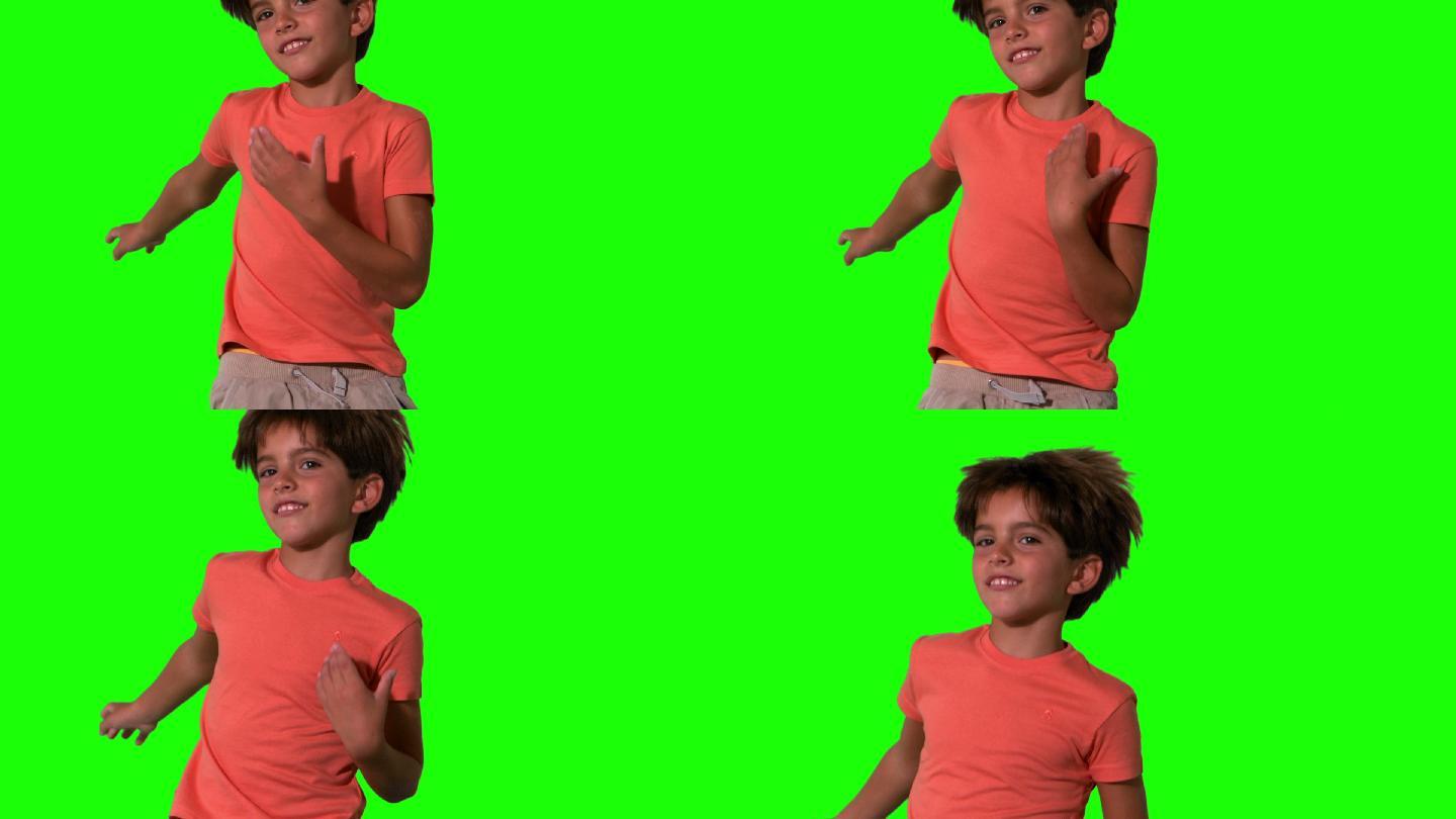 男孩跳跃在绿色屏幕上的特写慢动作
