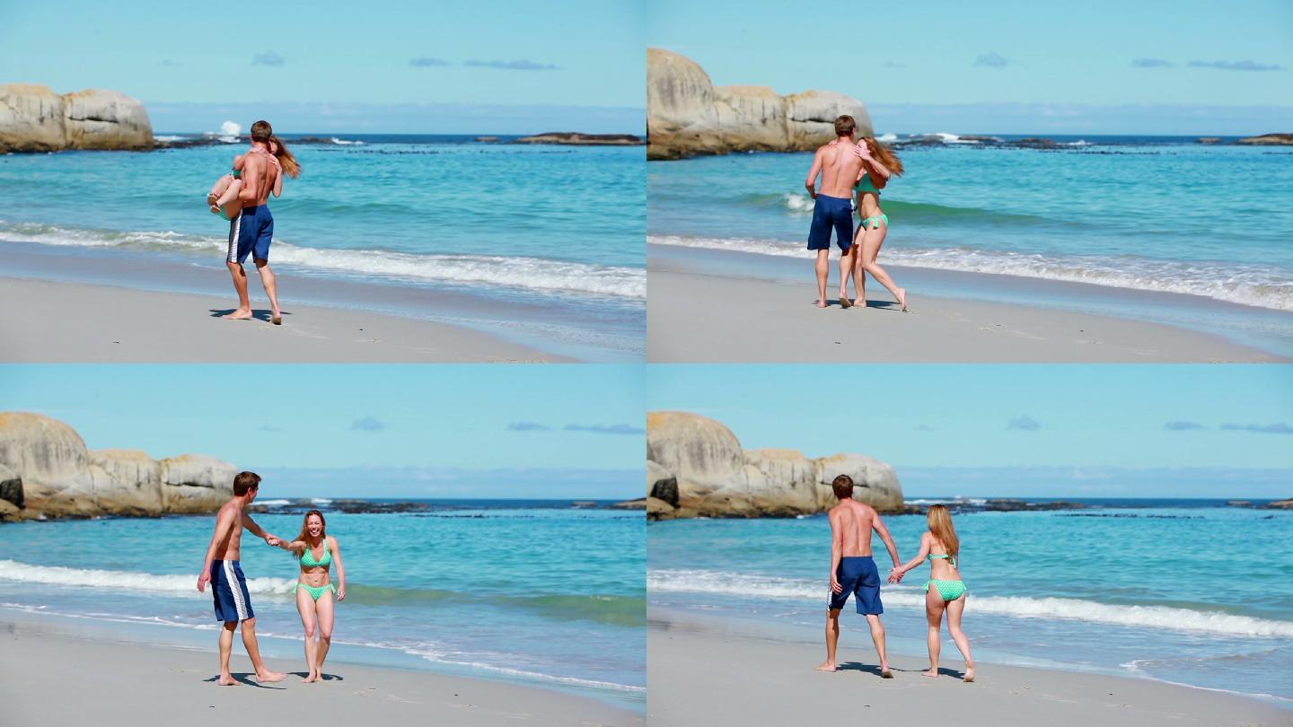 微笑的男人在海滩上抱着他的女朋友