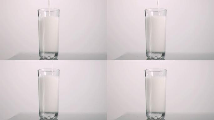 牛奶倒入玻璃杯慢动作，在灰色背景下