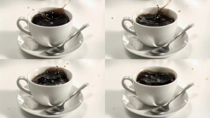 糖在白色背景下以超慢的动作落在一杯咖啡里