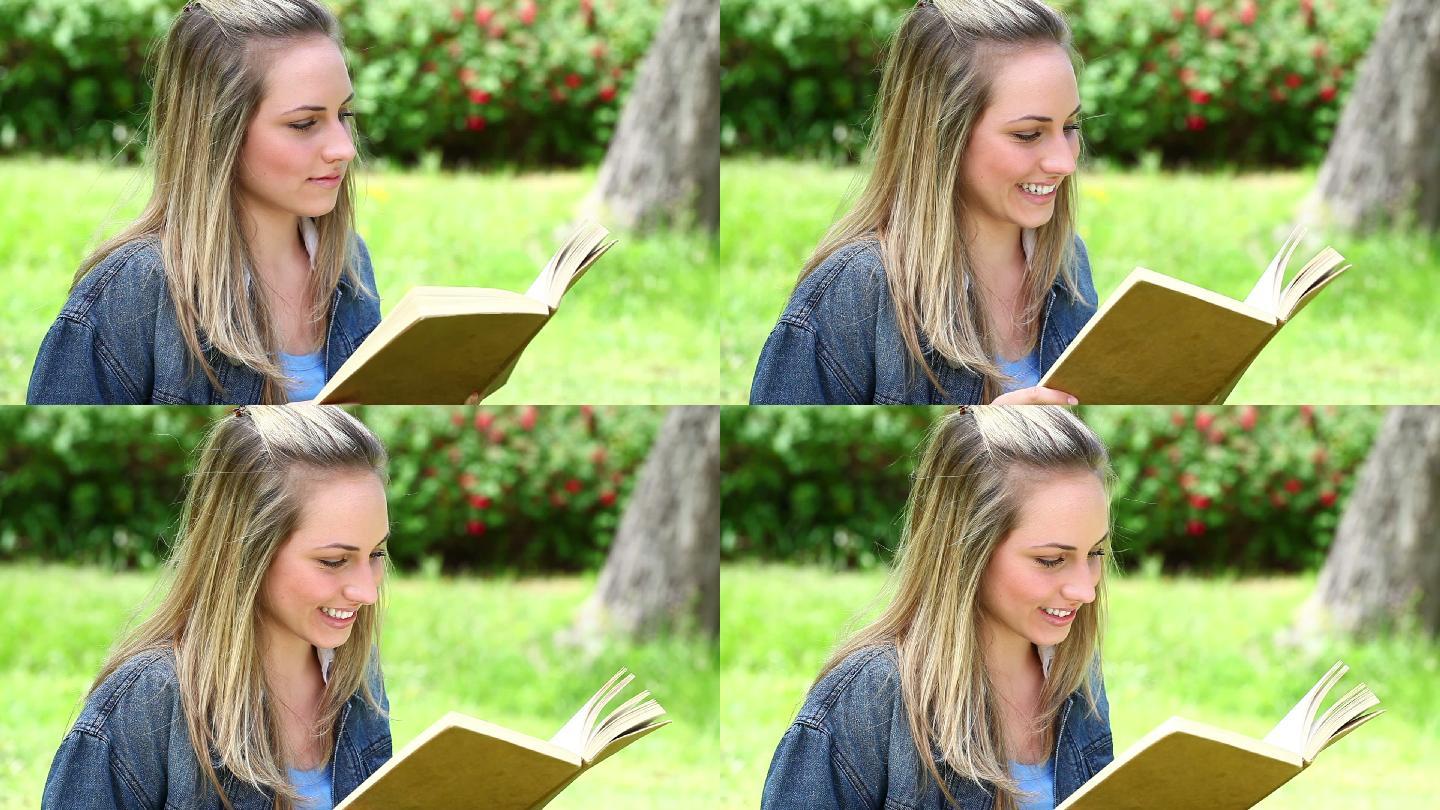 快乐的金发女人在乡下读小说
