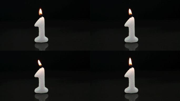 黑色背景上的第一支生日蜡烛