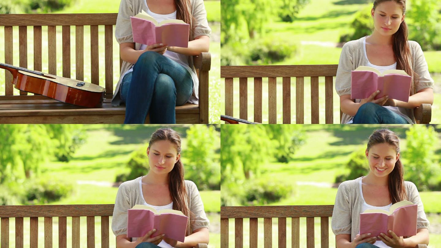 一个女人在长凳上看书，旁边放着一把吉他