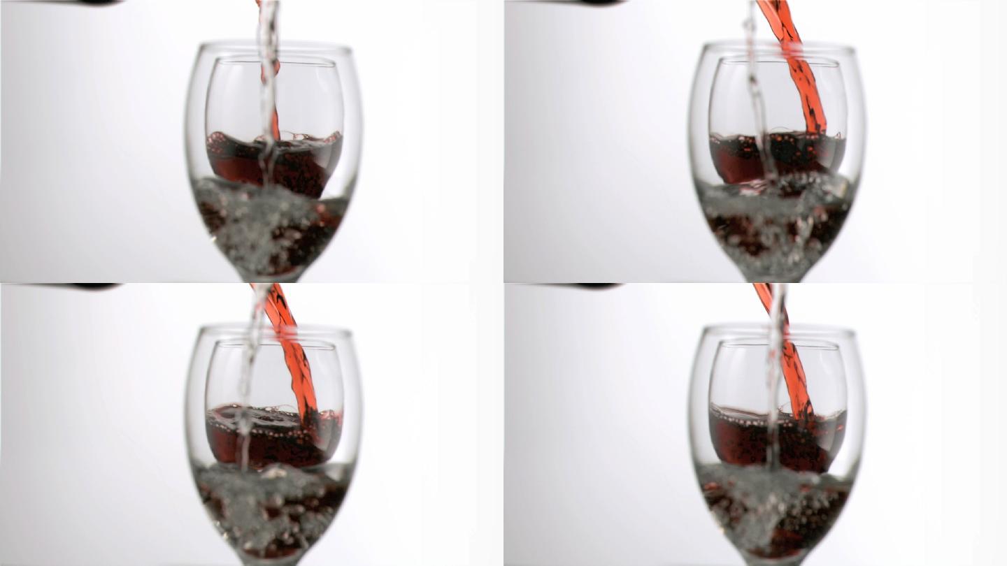 葡萄酒和水填在超级慢动作杯，在白色的背景