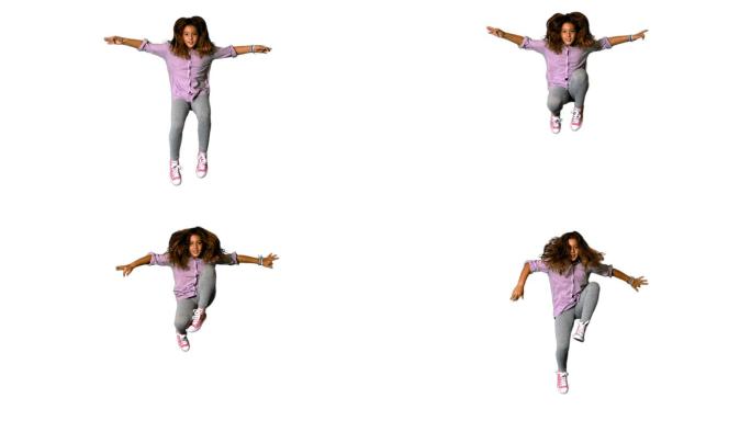 一个西方小女孩双臂伸展跳跃慢镜头，在白色背景下