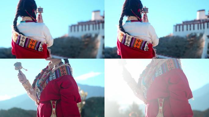 拿着转经筒祈福的藏族女孩