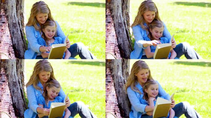 一个女人和她的女儿在公园里看书