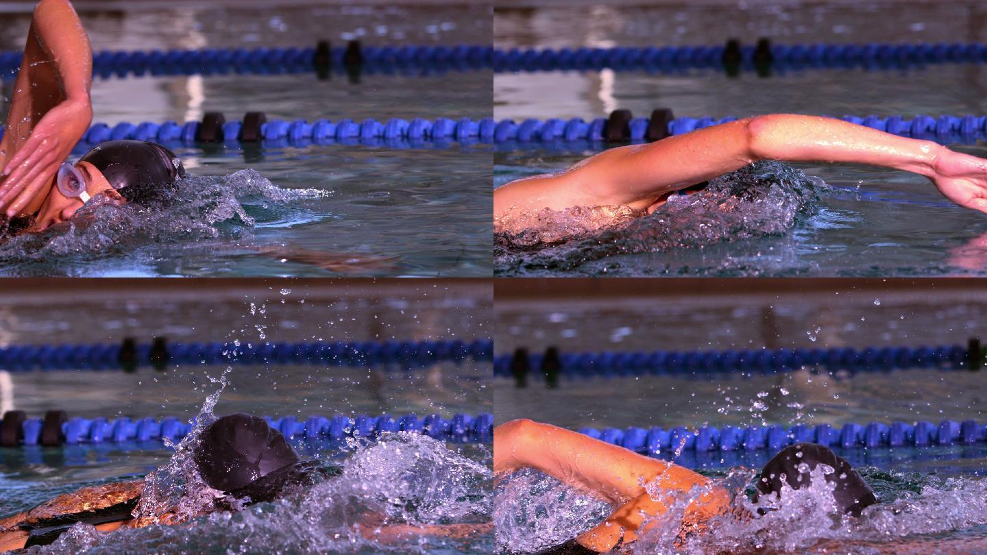 健康的游泳运动员在游泳池里用慢动作向前划水