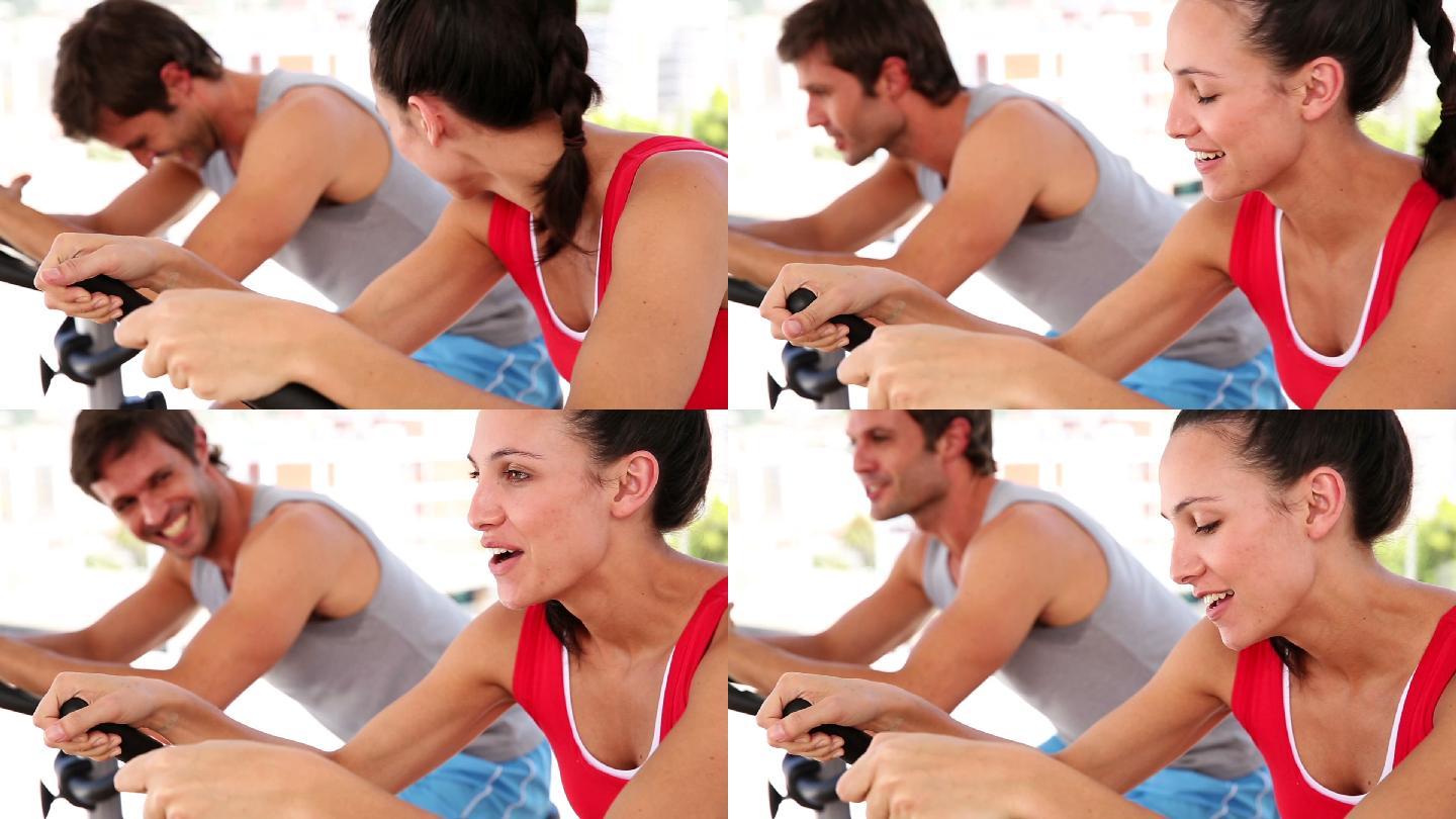一对情侣在健身房里骑自行车健身