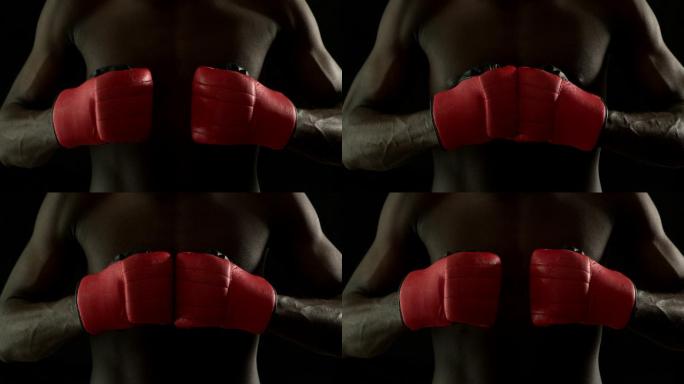 强硬的拳击手用红色的手套在慢动作拳在一起