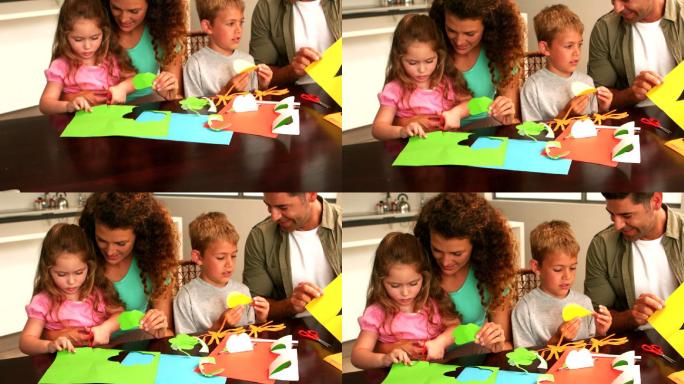 父母和孩子一起在桌子上用慢镜头画纸的形状
