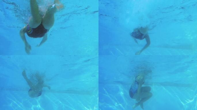 低角度视图的适合游泳者在游泳池做前划水