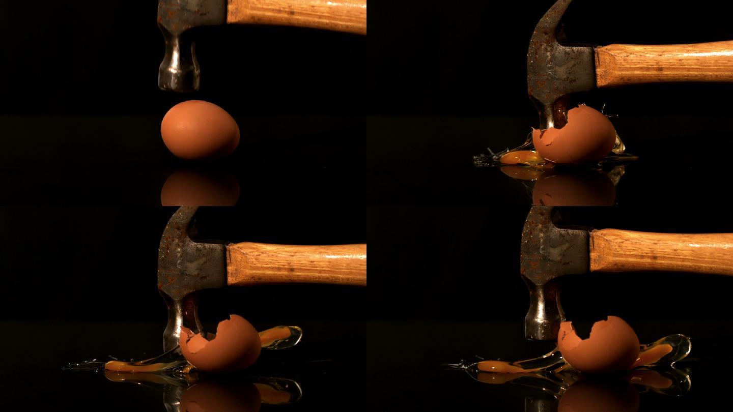 用锤子在黑色背景上砸鸡蛋的慢动作