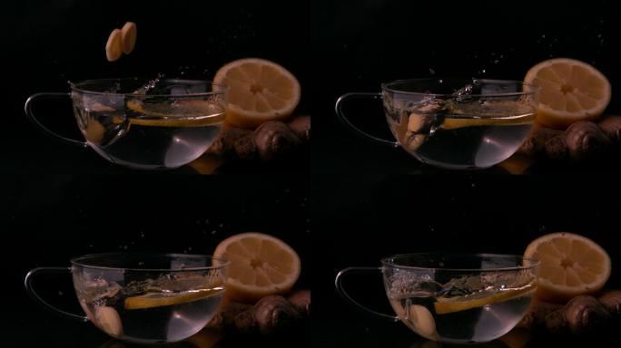 柠檬片在慢镜头中落入一杯水中
