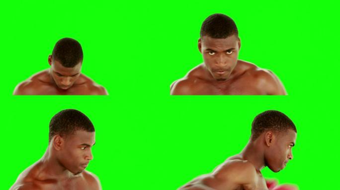 强硬的拳击手出拳与红色的手套在绿色的屏幕背景