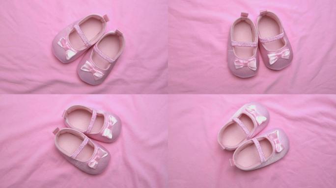 粉红色婴儿鞋在旋转的粉红色毯子表面