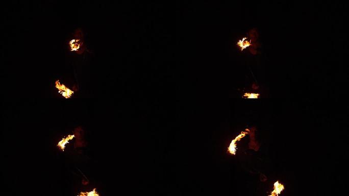 火焰舞者用慢动作在黑暗中划出火焰的痕迹