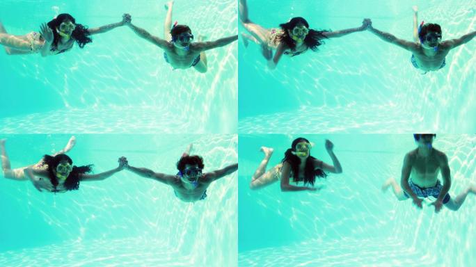 一对快乐的情侣在他们的假期里一起穿着通气管在游泳池里跳