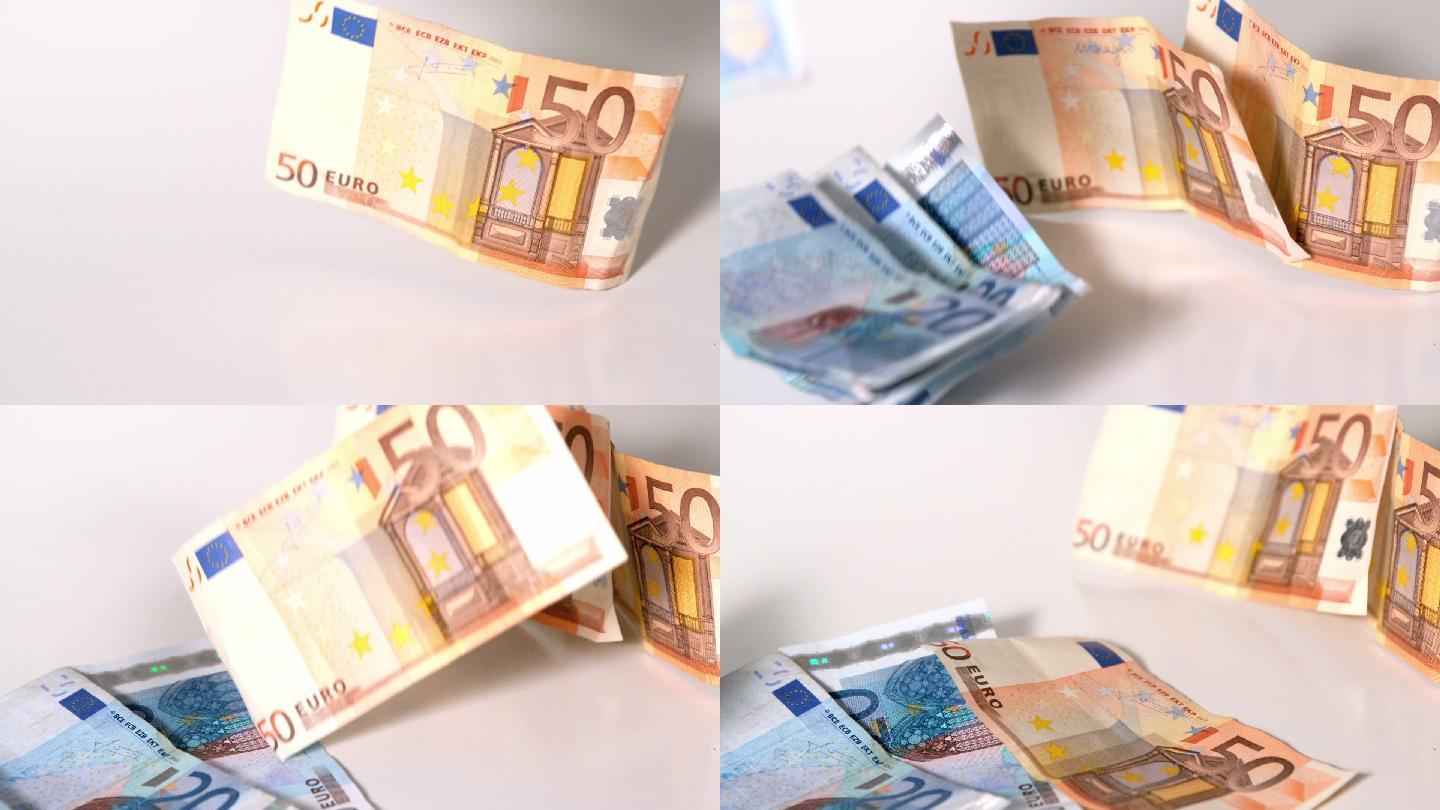 慢镜头中，欧元纸币落在白色的表面上