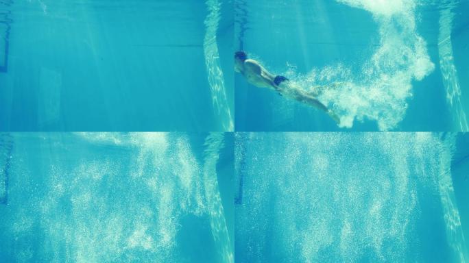 一个男人在度假时跳进蓝色的游泳池