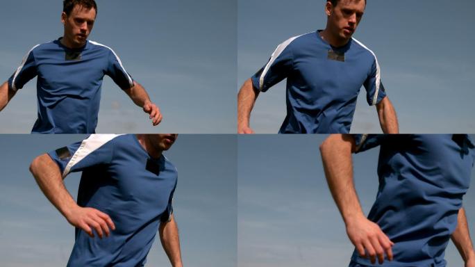 足球运动员在蓝天下慢镜头奔跑