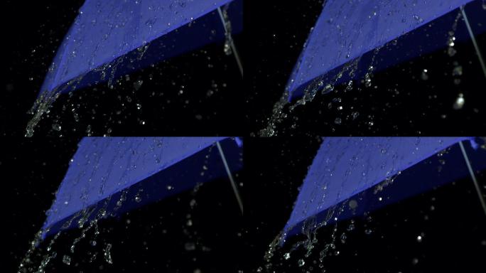 雨慢慢地落在蓝色的伞上
