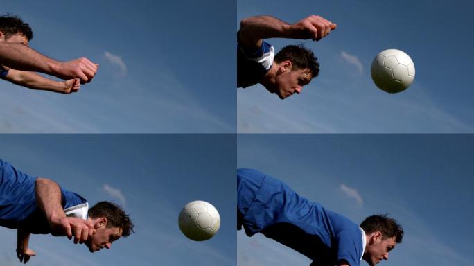 足球运动员在蓝天下用头顶球的慢动作