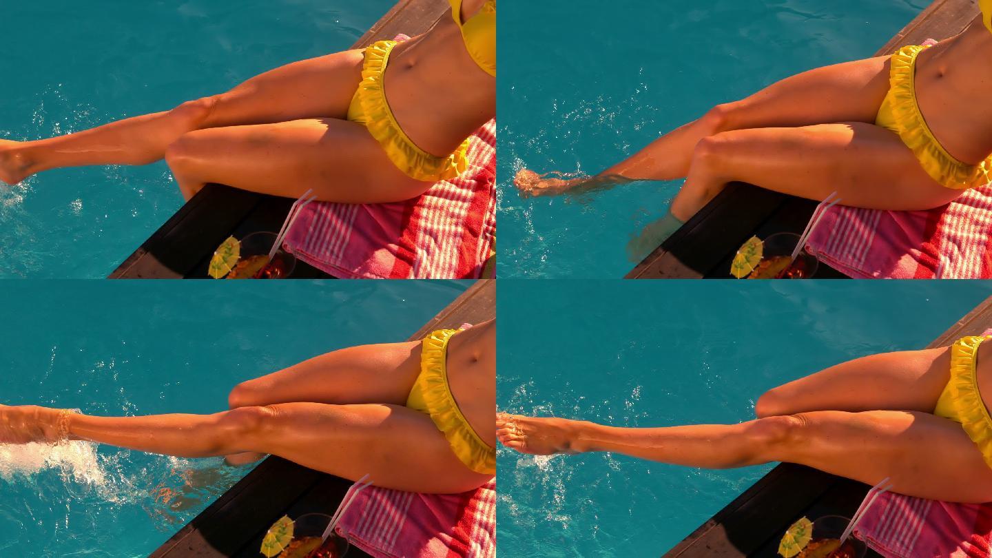 性感的女人在黄色比基尼在泳池边慢动作