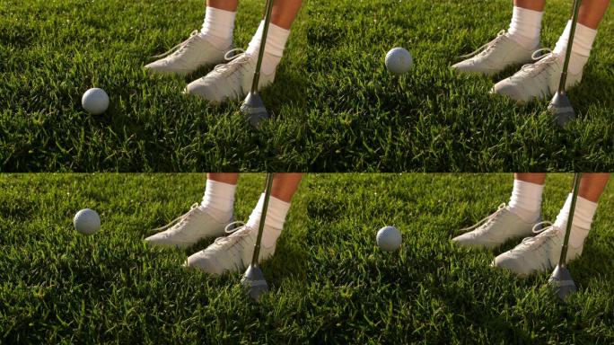 在慢动作中，高尔夫球落在女高尔夫球手的脚和球杆旁边
