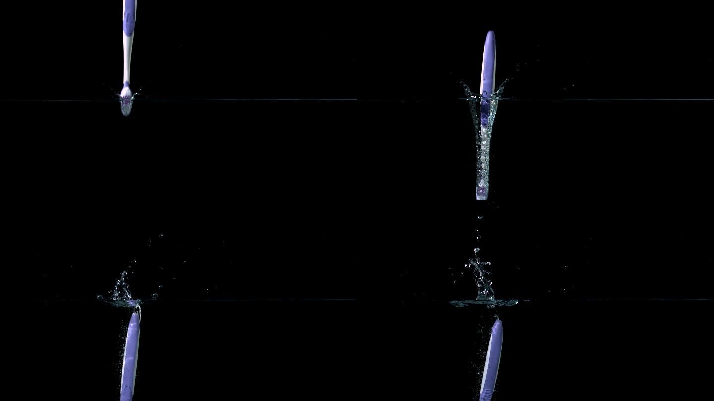 紫色的牙刷在黑色背景的慢镜头中落入水中