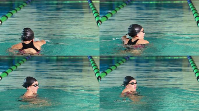健康的游泳者在休闲中心的游泳池里做前划