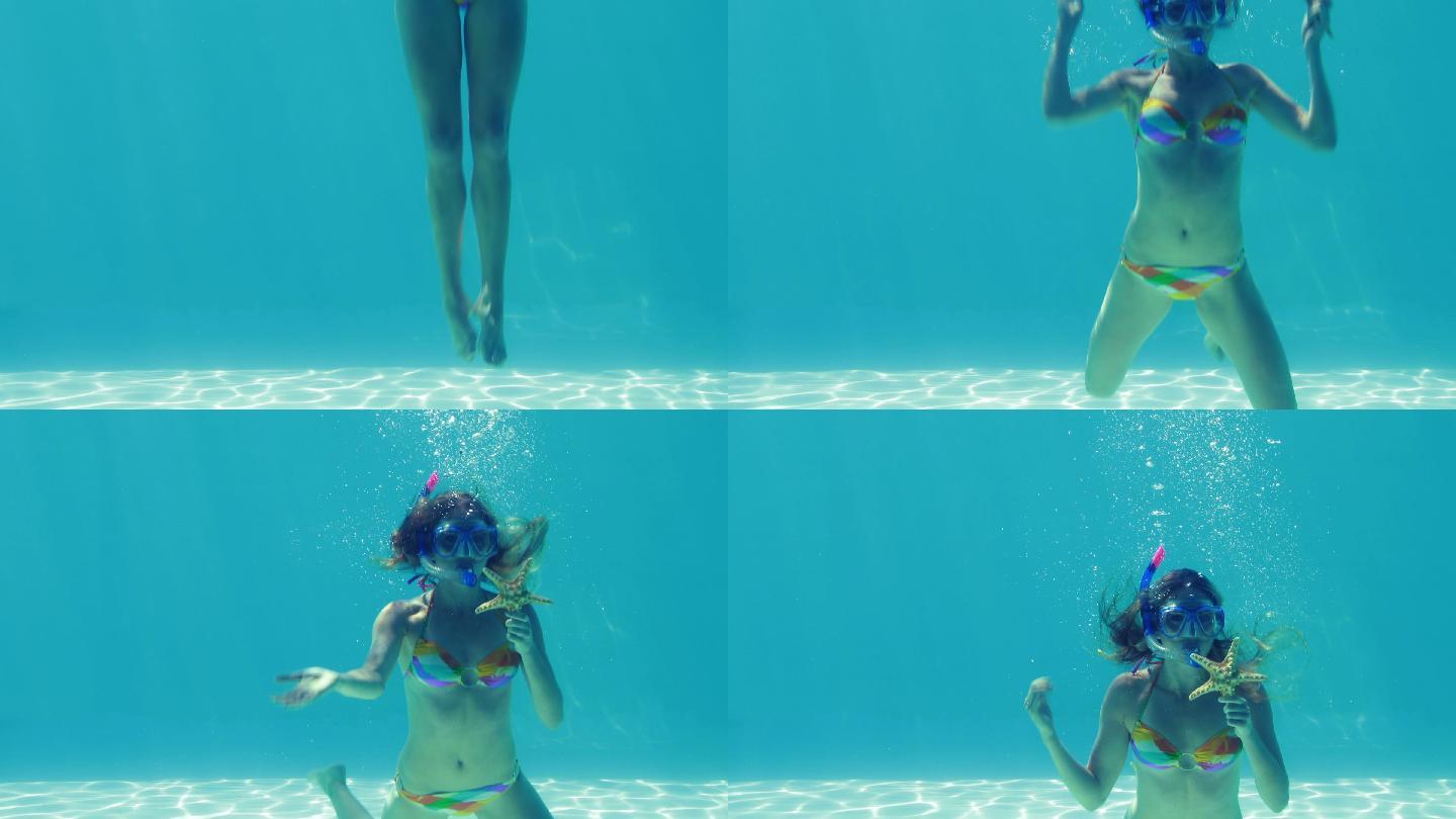 快乐的金发女郎穿着通气管跳进游泳池，在她的假期抱着海星