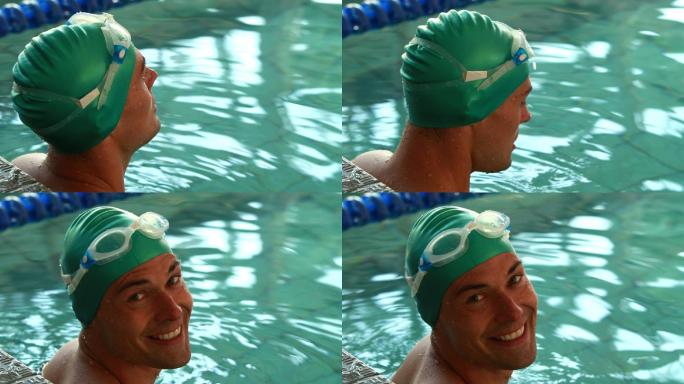 健身游泳者在休闲中心的游泳池对着镜头微笑